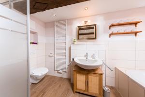 a white bathroom with a sink and a toilet at Ferienhaus Gertrud in Nesselwängle +151 photos