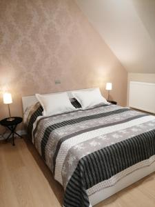 a bedroom with a large bed with two lamps at Akkerland - incl infra-red sauna - excl option hot swimspa from Spring-Halloween -1 bedroom 1-3 pers - 2 bedrooms 4-6 pers in Zonnebeke