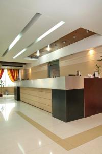 a lobby with a reception desk in a building at Richmond Hotel Sylhet in Sylhet