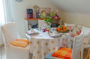 a table with a white table cloth and fruit on it at Villa Stephan in Extertal