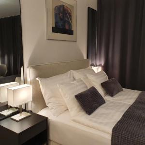 a bedroom with a white bed with two pillows at Myplace in Oulu Studio Koulukatu in Oulu