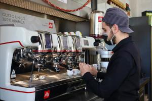 a man standing in a kitchen with a coffee machine at L'incontro in Trinitapoli