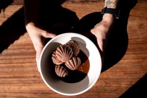 a person holding a cup of chocolate and nuts at Encuentro Guadalupe in Valle de Guadalupe