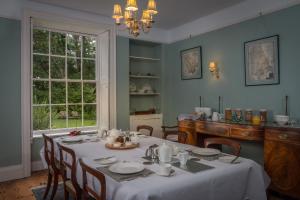 a dining room with a table and chairs and a window at The Old Vicarage B&B in Kenton