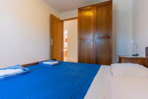 Кровать или кровати в номере Apartmani Valun1