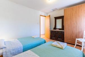 Кровать или кровати в номере Apartmani Valun1