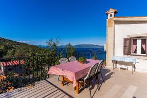 a table and chairs on a balcony with a view at Apartmani Valun1 in Valun