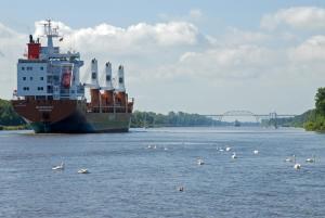 a large ship in a river with birds in the water at Kanal 33 in Schafstedt