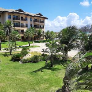 a resort with palm trees in front of a building at VG SUN CUMBUCO-Lake Flat C1 201 1 a 4 pessoas in Caucaia