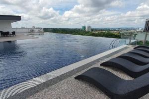 a swimming pool on the roof of a building at KOZI Square New SGH Cozy Home LV7B in Kuching