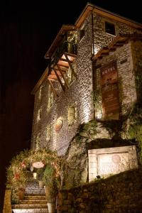 a stone building with christmas lights on it at Archontiko Deligianni in Dhimitsana