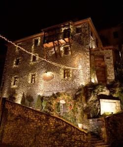 a large stone building with christmas lights on it at Archontiko Deligianni in Dhimitsana