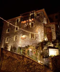 a large stone building with christmas lights on it at Archontiko Deligianni in Dimitsana