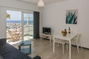 a living room with a table and a dining room at Los Panelos A2 A3 in Puerto del Carmen