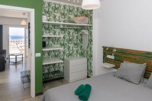 a bedroom with a bed and a green wall at Los Panelos A2 A3 in Puerto del Carmen