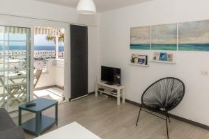 a living room with a couch and a television at Los Panelos A2 A3 in Puerto del Carmen