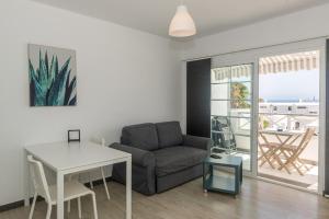a living room with a couch and a table at Los Panelos A2 A3 in Puerto del Carmen