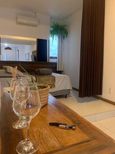 a table with two wine glasses and a bottle on it at BeMyGuest Floripa in Florianópolis +39 photos