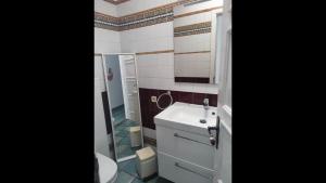 a bathroom with a sink and a toilet and a mirror at First Line Luxury Apartment by El Sirocco in Puerto de Mogán +23 photos