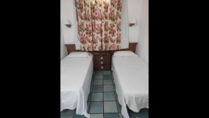 a pair of beds in a room with a window at First Line Luxury Apartment by El Sirocco in Puerto de Mogán