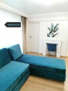 niebieską kanapę w salonie ze stołem w obiekcie Apartment no 05 - Amarilia Apartments w Konstancy