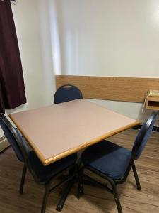 a table and two chairs in a room at Mountain View Motel in Smithers