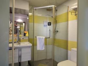 a bathroom with a shower and a sink and a toilet at 7Days Inn Chenzhou West High Speed Railway Station in Chenzhou