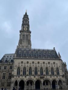a building with a clock tower on top of it at Superbe appartement en Centre ville d'ARRAS in Arras