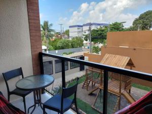 a balcony with a table and chairs and a table at Flat Casa da Praia in Porto De Galinhas