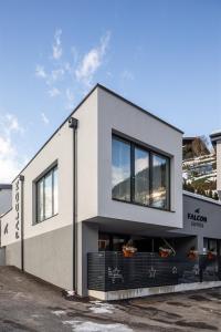 a white building with a lot of windows at Falcon Suites Zell am See in Zell am See