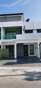 a large white building with a lot of windows at 48 悠之处NO . 48, PERSIARAN ALAM IMPIAN 3 VILLA RIADAH ALAM IMPIAN PANGKOR, 32300 PANGKOR , PERAK. in Pangkor