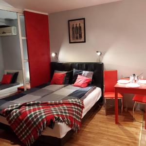 - une chambre avec un lit et une table avec une chaise dans l'établissement Savinac apartman u srcu Beograda, Trg Slavija, à Belgrade