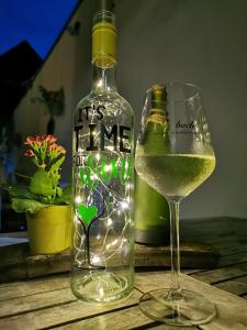 a bottle of wine and a glass on a table at Weingut Gästehaus Bach in Cochem