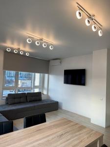 a living room with a couch and a flat screen tv at New 3 rooms apartment near the metro station in Kyiv