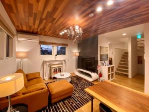 a living room with a couch and a fireplace at Vacanza gifu sauna villa in Gifu