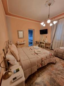 a bedroom with a large bed and a living room at B&B Le rose di Paola in Santa Maria a Monte