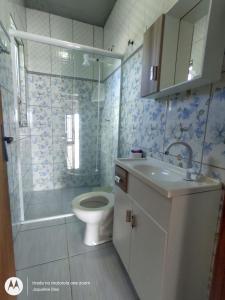 a bathroom with a toilet and a shower and a sink at Pousada Belas Praia - Ribanceira in Imbituba +29 photos