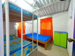 a bedroom with two bunk beds and a green cabinet at Las Cabañas de Mario in Necoclí