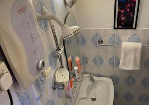 a bathroom with a mirror next to a toilet at Number 01 by Taprobane in Negombo