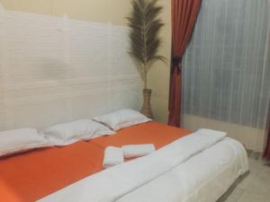 1 cama grande con 2 almohadas blancas. en House of Runsia Guesthouse, en Pagaralam