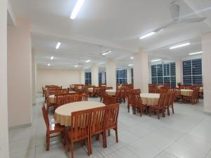 a dining room with tables and chairs and windows at Thanh Nien Hotel - Vung Tau in Vung Tau