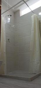 a bathroom with a shower with a shower curtain at Apto Casa Zeus Arboletes in Arboletes