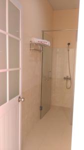 a bathroom with a shower with a glass door at Thanh Nien Hotel - Vung Tau in Vung Tau