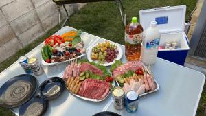 a table with three trays of food and bottles of water at rupo green in Ishigaki Island