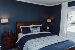 Кровать или кровати в номере Mountford Cottage