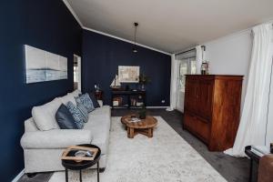 a living room with a couch and a table at Mountford Cottage in Metung