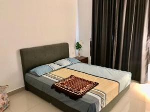 a bedroom with a bed in a room with a window at Der’s Apartment in Bandar Penawar