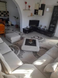 a living room with a couch and a table at Vila Xhipe in Korçë