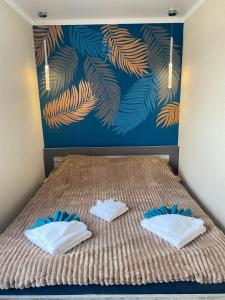 a bed with two pillows on it in a bedroom at Люкс апартаменти «Д.І.М.» in Kamianets-Podilskyi