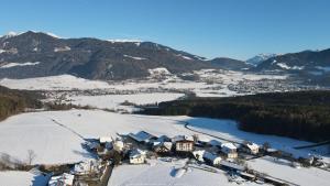 an aerial view of a ski resort in the snow at Appartement- und Wellnesshotel Winkler in Falzes